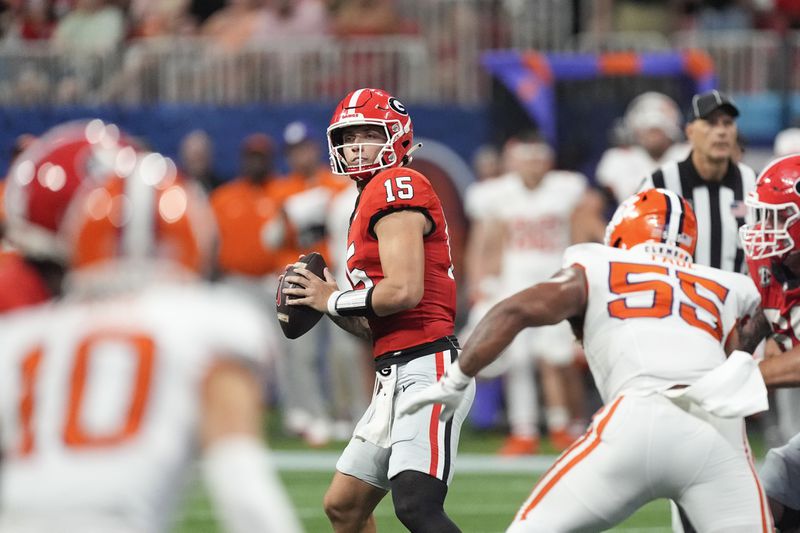 Georgia quarterback Carson Beck (15) throws from the pocket during the second half of an NCAA college football game against Clemson Aug. 31, 2024, in Atlanta. (AP Photo/John Bazemore)