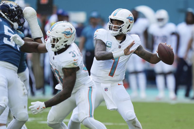 Miami Dolphins quarterback Tua Tagovailoa (1) aims a pass during the first half of an NFL football game against the Jacksonville Jaguars, Sunday, Sept. 8, 2024, in Miami Gardens, Fla. (AP Photo/Wilfredo Lee)