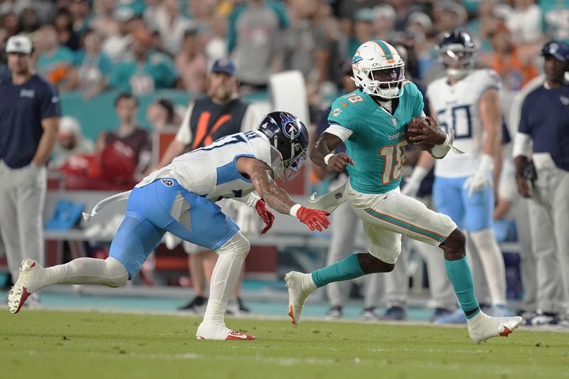 Tennessee Titans safety Amani Hooker (37) goes after Miami Dolphins quarterback Tyler Huntley (18) during the first half of an NFL football game, Monday, Sept. 30, 2024, in Miami Gardens, Fla. (AP Photo/Rebecca Blackwell)