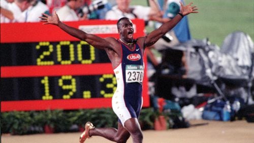 The one-word headline said "WHOOOOOOSH!," above this photo in 1996. Wearing golden shoes, Michael Johnson reacts as he realizes he has set a world record in the 200-meter event during the 1996 Summer Olympics in Atlanta. (AJC Staff Photo/Jonathan Newton)