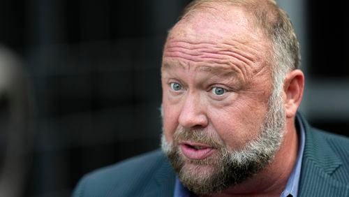 Right-wing conspiracy theorist Alex Jones speaks to the media after arriving at the federal courthouse for a hearing in front of a bankruptcy judge Friday, June 14, 2024, in Houston. The judge is expected to rule on whether to liquidate Jones' assets to help pay the $1.5 billion he owes for his false claims that the Sandy Hook Elementary School shooting was a hoax. (AP Photo/David J. Phillip)