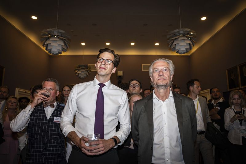Party leader of the Liberal Alliance Alex Vanopslagh, left, and party member Henrik Dahl stand during an election party at Christiansborg in Copenhagen, Sunday, June 9, 2024. (Emil Nicolai Helms/Ritzau Scanpix via AP)