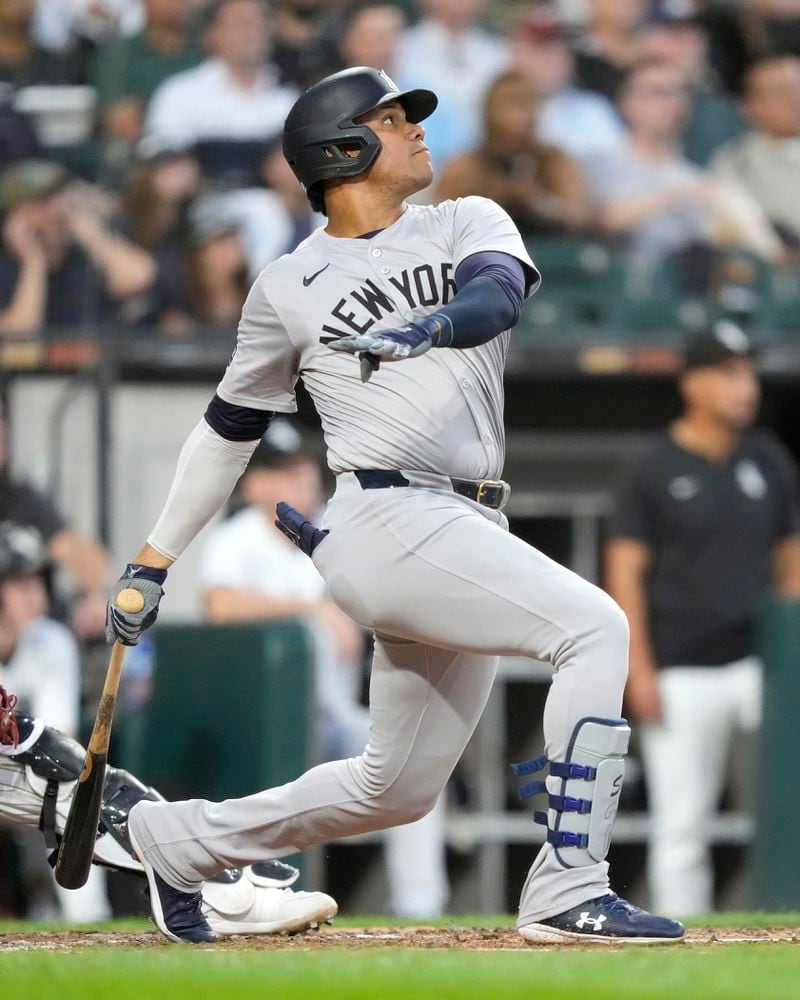 New York Yankees' Juan Soto watches his two-run home run off Chicago White Sox starting pitcher Jonathan Cannon during the third inning of a baseball game Tuesday, Aug. 13, 2024, in Chicago. (AP Photo/Charles Rex Arbogast)