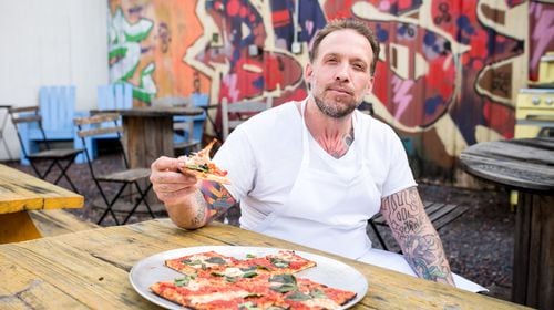 Anthony Spina enjoying the Grandma Pie at O4W Pizza. Photo Credit- Mia Yakel.