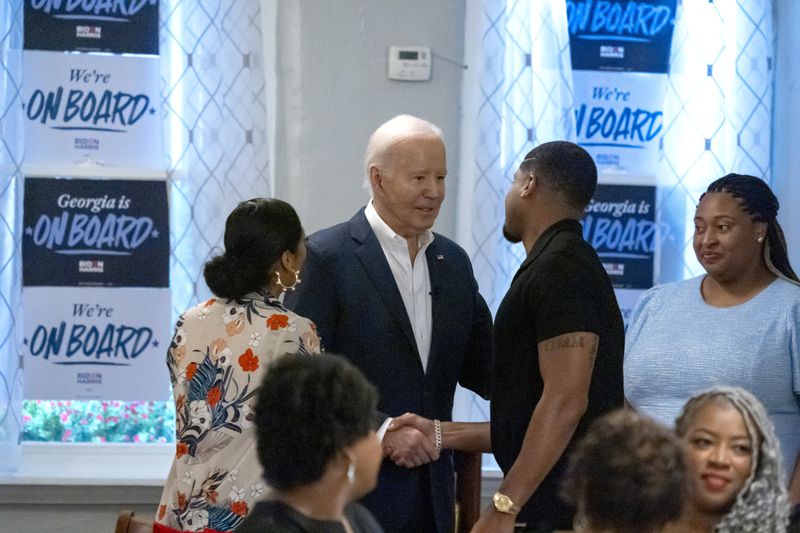 President Joe Biden, center, speaks with supporters at Mary Mac's Tea Room, Saturday, May 18, 2024, in Atlanta. (AP Photo/Alex Brandon)
