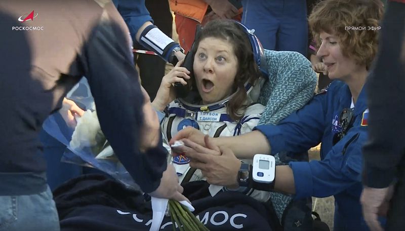 In this photo taken from video released by Roscosmos space corporation, the NASA astronaut Tracy Dyson is gifted with flowers shortly after the landing of the Russian Soyuz MS-25 space capsule carrying the NASA astronaut Tracy Dyson and the Roscosmos cosmonauts Oleg Kononenko and Nikolai Chub, south-east of the Kazakh town of Zhezkazgan, Kazakhstan, Monday, Sept. 23, 2024. (Roscosmos space corporation via AP)