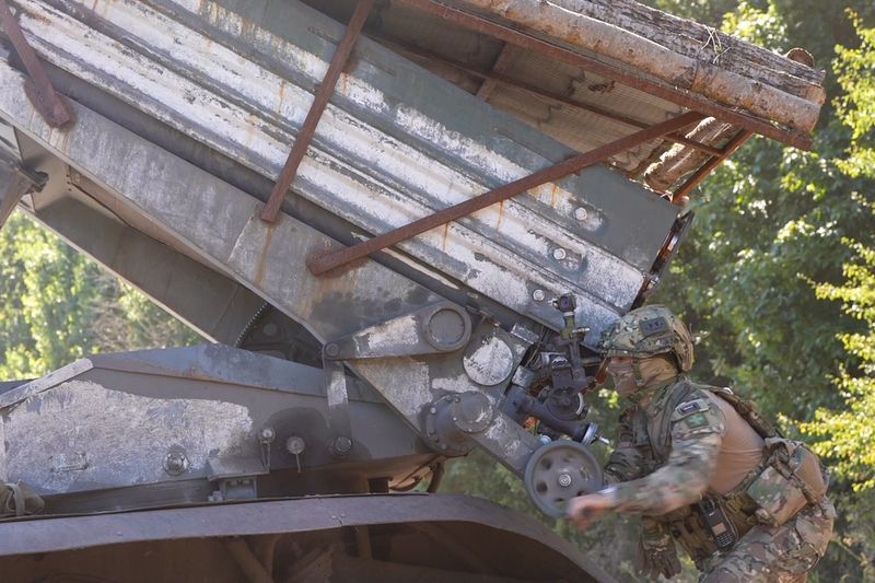 In this photo taken from video released by Russian Defense Ministry press service on Thursday, Aug. 22, 2024, Russian serviceman aims a Grad self-propelled 122 mm multiple rocket launcher in a border area of Kursk region, Russia. (Russian Defense Ministry Press Service via AP)