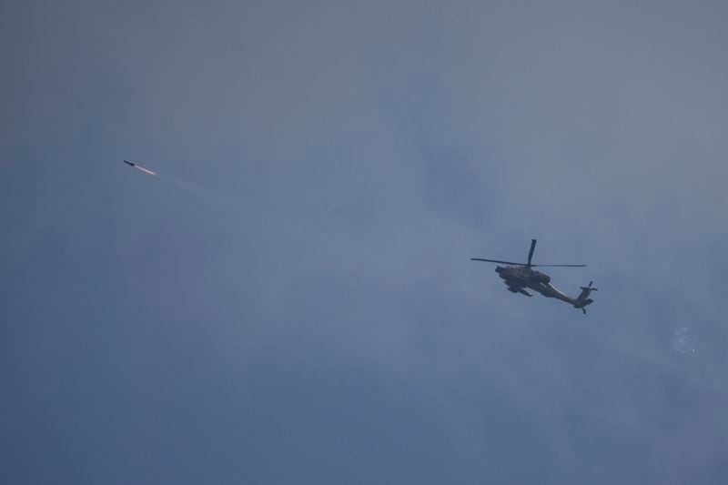 An Israeli Apache helicopter fires a missile towards southern Lebanon as seen from northern Israel, Tuesday, Oct. 1, 2024. (AP Photo/Leo Correa)