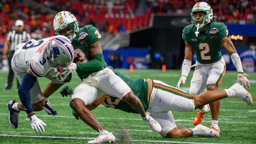 Wide receiver Kasey Hawthorne, Howard University, pushes past defensive back Kendall Bohler, Florida A&M, for a touchdown at the Celebration Bowl, Howard University versus Florida A&M, at Mercedes Benz Stadium in Atlanta, Georgia on December 16, 2023. (Jamie Spaar for the Atlanta Journal Constitution)