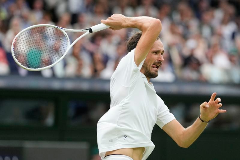Daniil Medvedev of Russia plays a forehand return to Jannik Sinner of Italy during their quarterfinal match at the Wimbledon tennis championships in London, Tuesday, July 9, 2024. (AP Photo/Alberto Pezzali)