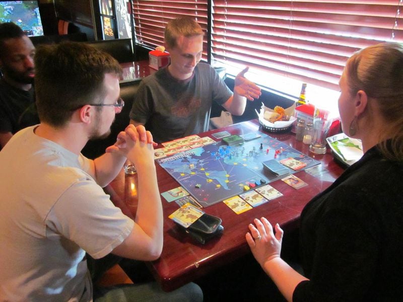 Customers at Battle & Brew restaurant/video and board game venue, with locations in Atlanta and Sandy Springs, can choose from a selection of board games to play with family or friends.
(Courtesy of Battle & Brew)