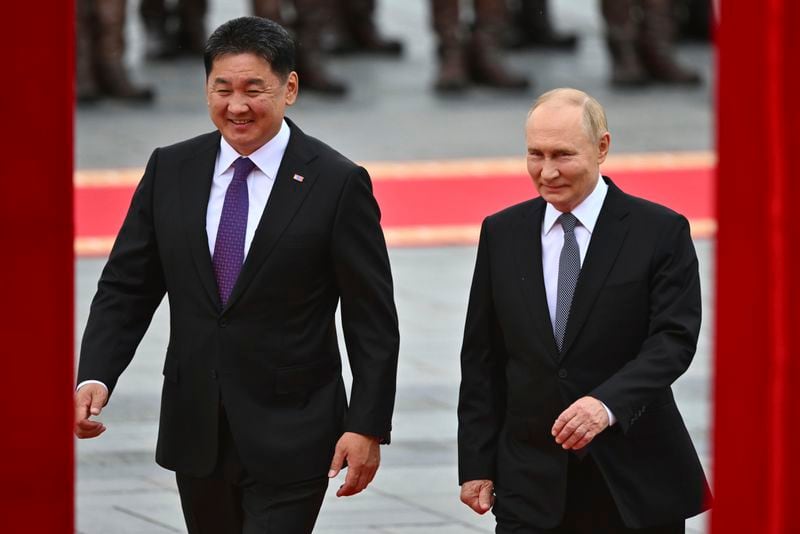 Russian President Vladimir Putin, right, walks with Mongolian President Ukhnaagiin Khurelsukh, left, during welcoming ceremony at Sukhbaatar Square in Ulaanbaatar, Mongolia, Tuesday, Sept. 3, 2024. (Kristina Kormilitsyna, Sputnik, Kremlin Pool Photo via AP)