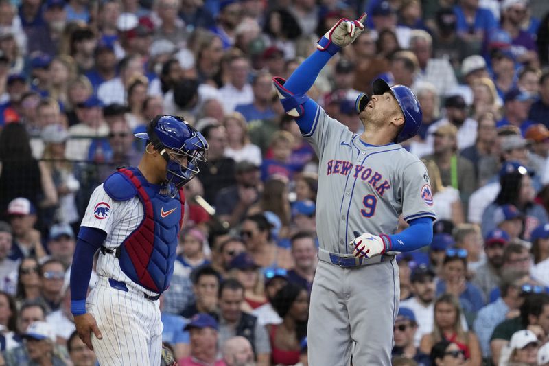 New York Mets' Brandon Nimmo, right, celebrates after hitting a solo home run as Chicago Cubs catcher Miguel Amaya looks down during the third inning of a baseball game against the Chicago Cubs in Chicago, Sunday, June 23, 2024. (AP Photo/Nam Y. Huh)