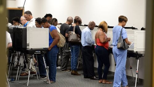 DeKalb County voters line up for early voting at the county Voter Registration & Elections office Oct. 17. KENT D. JOHNSON / KDJOHNSON@AJC.COM