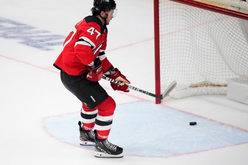 New Jersey Devils' Paul Cotter scores his side's fourth goal during the NHL hockey game between Buffalo Sabres and New Jersey Devils, in Prague, Czech Republic, Friday, Oct. 4, 2024. (AP Photo/Petr David Josek)