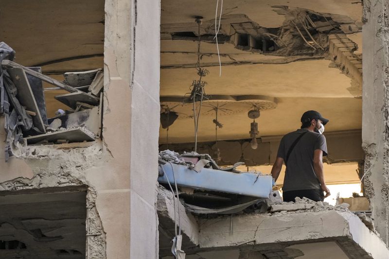 A resident checks an apartment that was hit by an Israeli airstrike in Beirut's southern suburbs, Thursday, Sept. 26, 2024. (AP Photo/Hassan Ammar)