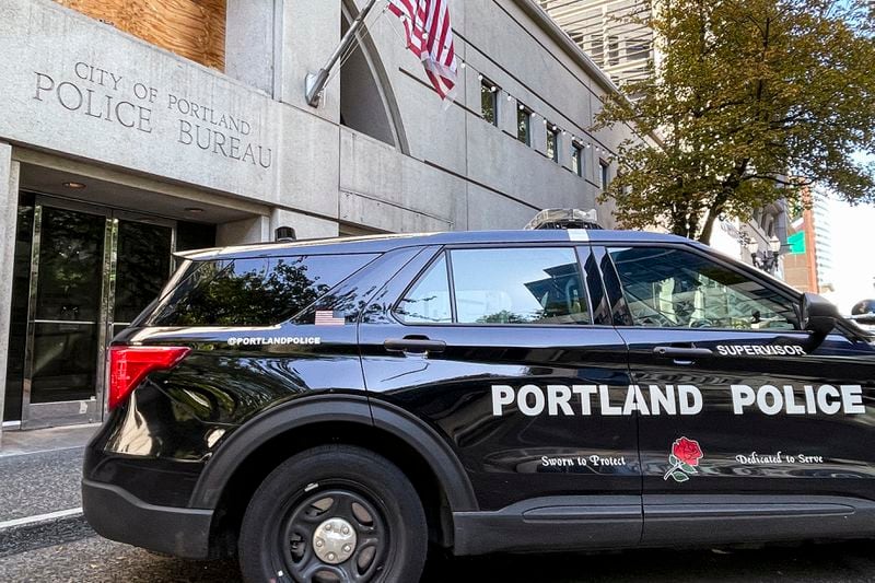 A police vehicle is parked outside police headquarters in Portland, Ore., Friday, Aug. 30, 2024. (AP Photo/Claire Rush)