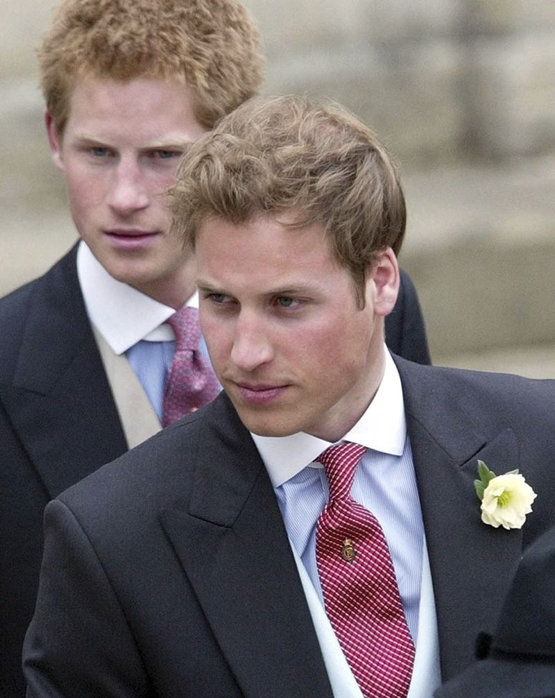 FILE - Britain's Prince William, right, and Prince Harry, left, after the marriage of their father Britain's Prince Charles, the Prince of Wales, and his wife Camilla, the Duchess of Cornwall, at the Guildhall in Windsor, England, after their civil wedding ceremony, on April 9, 2005. (AP Photo/Dave Caulkin, File)