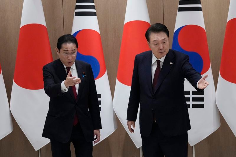 South Korean President Yoon Suk Yeol, right, and Japanese Prime Minister Fumio Kishida gesture during a meeting at the Presidential Office in Seoul, South Korea, Sunday, May 26, 2024. (AP Photo/Ahn Young-joon, Pool)