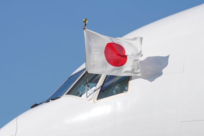 The Japanese flag flies form the cockpit window of the plane carring Emperor Naruhito and Empress Masako as it arrives at Stansted Airport, England, Saturday, June 22, 2024, ahead of a state visit. The state visit begins Tuesday, when King Charles III and Queen Camilla will formally welcome the Emperor and Empress before taking a ceremonial carriage ride to Buckingham Palace. (AP Photo/Kin Cheung)