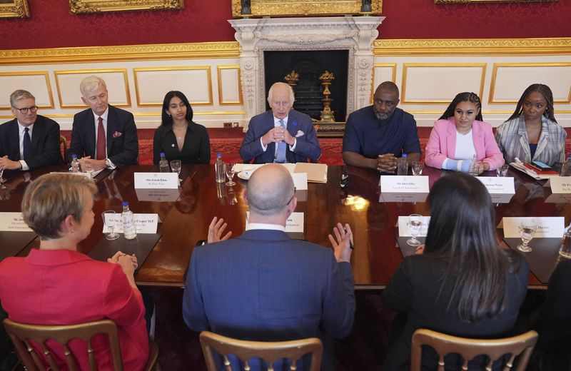 King Charles III (back centre), Idris Elba (back centre right) and Prime Minister Sir Keir Starmer (left) at an event for The King's Trust to discuss youth opportunity, at St James's Palace in central London, Friday July 12, 2024. The King and Mr Elba, an alumnus of The King's Trust (formerly known as The Prince's Trust), are meeting about the charity's ongoing work to support young people, and creating positive opportunities and initiatives which might help address youth violence in the UK, as well as the collaboration in Sierra Leone between the Prince's Trust International and the Elba Hope Foundation. (Yui Mok/pool photo via AP)
