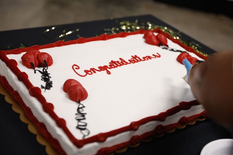 A congratulations cake is cut following a graduation ceremony for inmates receiving GEDs at Cobb County Detention Facility in Marietta on Tuesday, May 28, 2024. (Natrice Miller/ AJC)