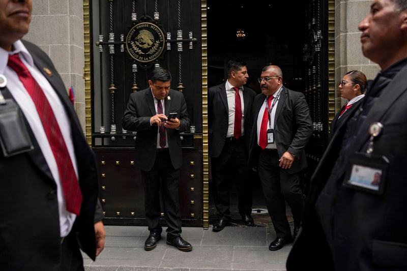 Security guards control access to an alternate headquarters for senators to discuss judicial reform that would require all judges to stand for election, in Mexico City, Thursday, Sept. 5, 2024, one day after Mexico's lower house approved the legislation. (AP Photo/Felix Marquez)