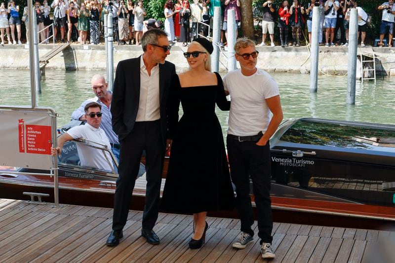 Director Todd Phillips, from left, Lady Gaga and Joaquin Phoenix pose for photographers upon arrival for the press conference of the film 'Joker: Folie A Deux' during the 81st edition of the Venice Film Festival in Venice, Italy, on Wednesday, Sept. 4, 2024. (Photo by Joel C Ryan/Invision/AP)