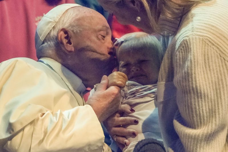 Pope Francis kisses a child during the Hope Happening youth festival at the Brussels Expo, Belgium, Saturday, Sept. 28, 2024, on the third day of his four-day visit to Luxembourg and Belgium. (AP Photo/Andrew Medichini)