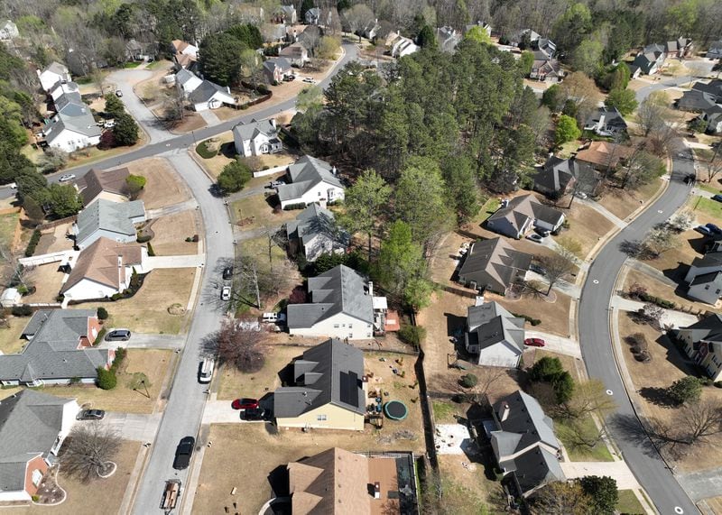 Aerial photograph shows solar panels on Alex Betancourt’s roof (middle lower) in Deer Valley subdivision, Friday, March 24, 2023, in Suwanee. Alex Betancourt put solar panels on his roof last year. He received letters from his HOA claiming the panels were an architectural addition that violated the community's rules. Now, they're threatening to forcibly remove the panels from his roof. (Hyosub Shin / Hyosub.Shin@ajc.com)