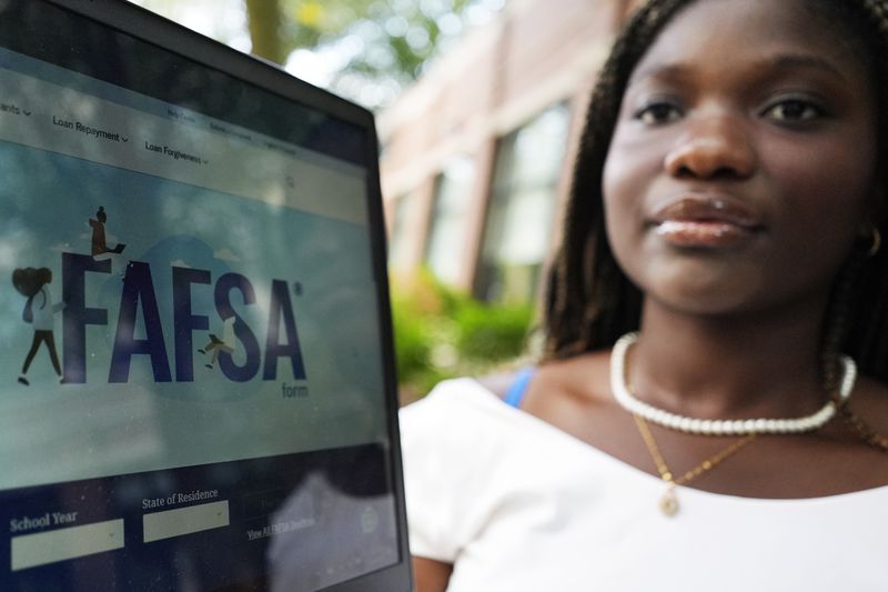 FAFSA website is seen on the laptop as Adjovi Golo holds a laptop at DePaul University in Chicago, Wednesday, Aug. 28, 2024. (AP Photo/Nam Y. Huh)