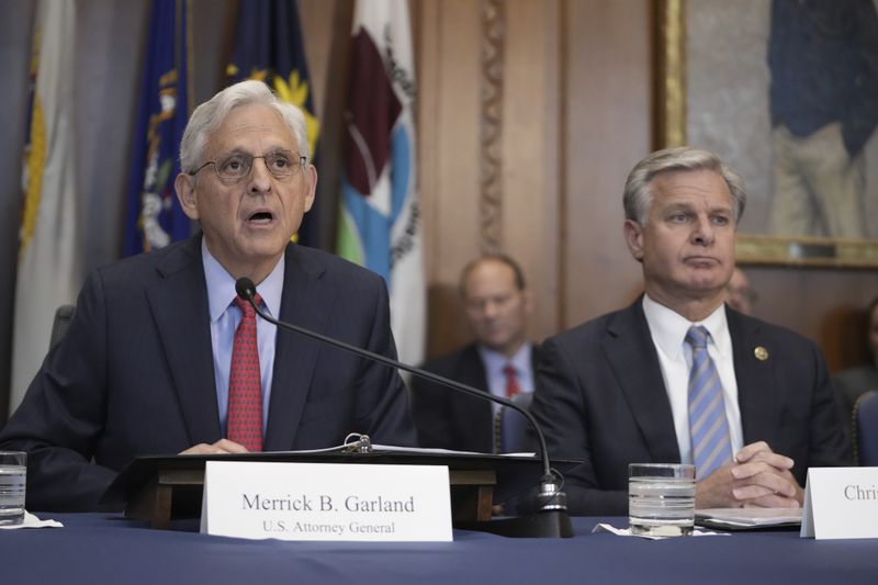 Attorney General Merrick Garland speaks during a meeting of the Justice Department's Election Threats Task Force, at the Department of Justice, Wednesday, Sept. 4, 2024, in Washington, with FBI Director Christopher Wray, right. (AP Photo/Mark Schiefelbein)