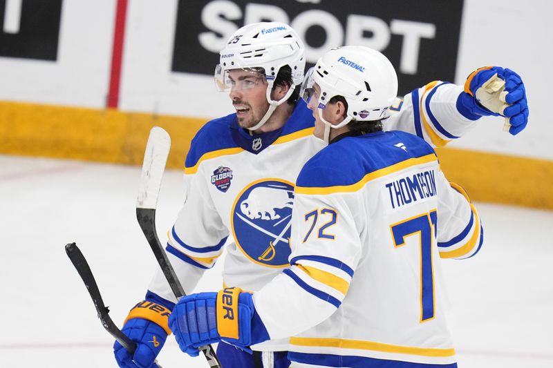 Buffalo Sabres' Owen Power, left, celebrates with Buffalo Sabres' Tage Thompson after scoring his side's first goal during the NHL hockey game between Buffalo Sabres and New Jersey Devils, in Prague, Czech Republic, Friday, Oct. 4, 2024. (AP Photo/Petr David Josek)