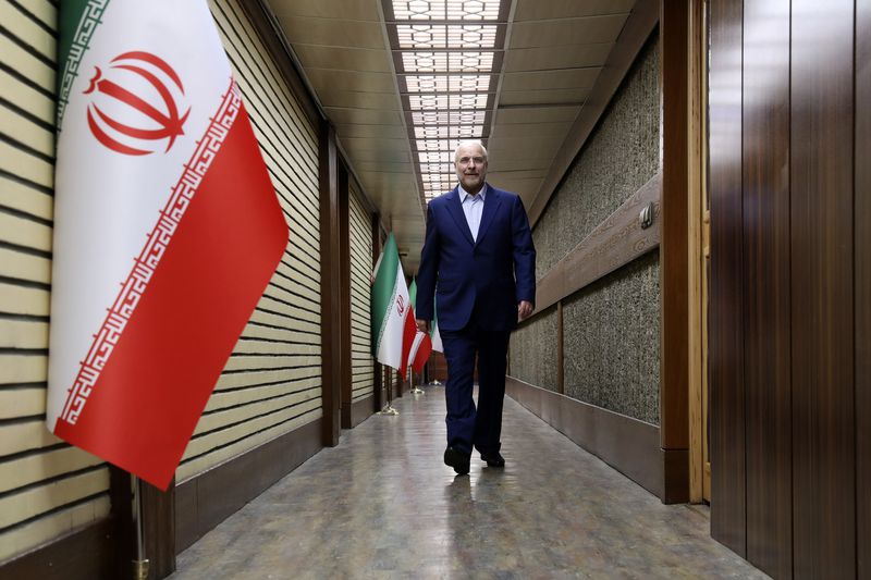In this picture made available by Iranian state-run TV, IRIB, Iran's Parliament Speaker Mohammad Bagher Qalibaf, a presidential candidate for June 28, election arrives for a debate of the candidates at the TV studio in Tehran, Iran, Thursday, June 20, 2024. (Morteza Fakhri Nezhad/IRIB via AP)