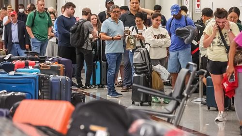 A meltdown of Delta flight operations continued Monday, July 22, 2024, and passengers waited in long lines at Hartsfield-Jackson International Airport trying to retrieve their checked bags and get customer service help. (John Spink / John.Spink@ajc.com)