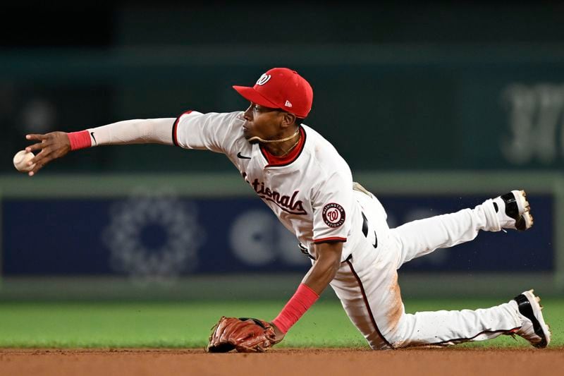 Washington Nationals second baseman Darren Baker tosses the ball to second base to create a double play to end the ninth inning of a baseball game against the Atlanta Braves, Tuesday, Sept. 10, 2024, in Washington. (AP Photo/John McDonnell)