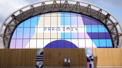 Tourists photograph near the Champ-de-Mars Arena, ahead of the 2024 Summer Olympics, Wednesday, July 24, 2024, in Paris, France. (AP Photo/Eugene Hoshiko)