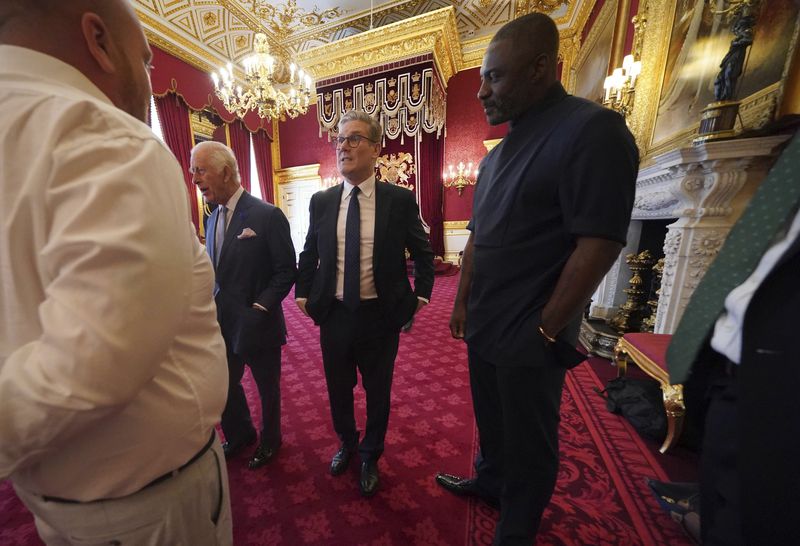 King Charles III (left), Idris Elba (right) and Prime Minister Sir Keir Starmer (centre) at an event for The King's Trust to discuss youth opportunity, at St James's Palace in central London, Friday July 12, 2024. The King and Mr Elba, an alumnus of The King's Trust (formerly known as The Prince's Trust), are meeting about the charity's ongoing work to support young people, and creating positive opportunities and initiatives which might help address youth violence in the UK, as well as the collaboration in Sierra Leone between the Prince's Trust International and the Elba Hope Foundation. (Yui Mok/pool photo via AP)
