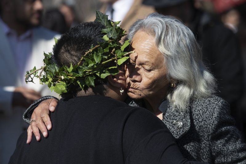 Mourners react outside Turangawaewae marae for the funeral of New Zealand's Māori King, Kiingi Tuheitia Pootatau Te Wherowhero VII, Thursday, Sept. 5, 2024, in Ngaruawahia, New Zealand. (AP Photo/Alan Gibson)