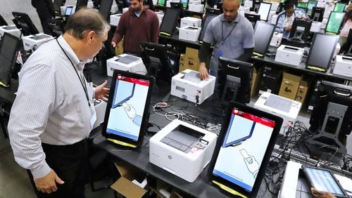 Project manager Tom Feehan looks over some of the state’s new voting machines while thousands are tested and packed in a area warehouse on Tuesday, January 14, 2020, in Atlanta. Curtis Compton / ccompton@ajc.com