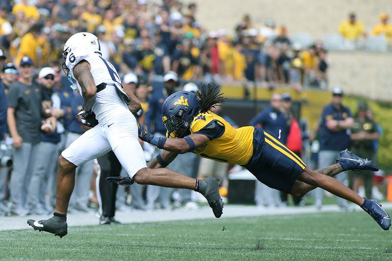 Penn State wide receiver Harrison Wallace III (6) is defended by West Virginia cornerback Garnett Hollis Jr. (1) during the first half of an NCAA college football game in Morgantown, W.Va., Saturday, Aug. 31, 2024. (AP Photo/Kathleen Batten)