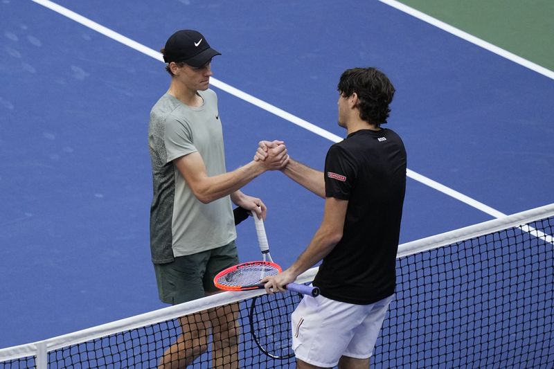 Jannik Sinner, left, of Italy, greets Taylor Fritz, of the United States, after winning the men's singles final of the U.S. Open tennis championships, Sunday, Sept. 8, in New York. 2024. (AP Photo/Frank Franklin II)