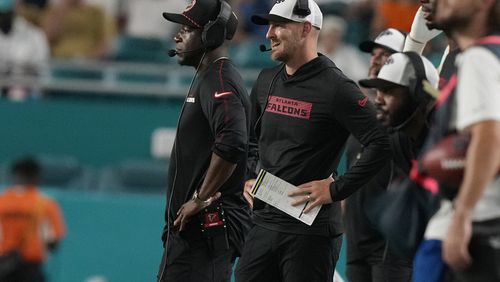 Atlanta Falcons head coach Raheem Morris (left) and quarterback Kirk Cousins watch from the sidelines during the second half of a preseason NFL football game against the Miami Dolphins, Friday, Aug. 9, 2024, in Miami Gardens, Fla. The Falcons lost 20-13.  (AP Photo/Lynne Sladky)