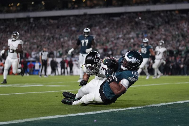 Philadelphia Eagles running back Saquon Barkley (26) catches a pass in front of Atlanta Falcons safety Jessie Bates III (3) during the second half of an NFL football game Monday, Sept. 16, 2024, in Philadelphia. (AP Photo/Matt Slocum)