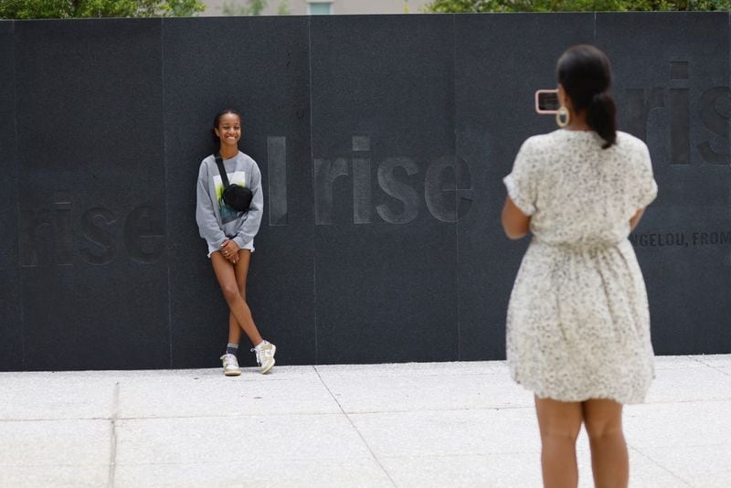 Granite walls stand on the grounds where enslaved Africans were held before they were sold. The walls feature the inspirational words of Maya Angelou.