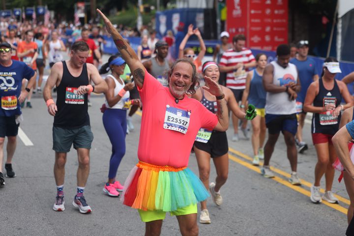 James Ennis celebrates at the finish line of the 55th running of the Atlanta Journal-Constitution Peachtree Road Race in Atlanta on Thursday, July 4, 2024.   (Jason Getz / AJC)