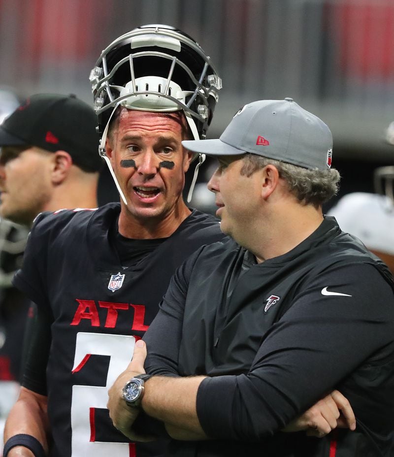 Falcons quarterback Matt Ryan confers with head coach Arthur Smith as they prepare to play the Cleveland Browns in the final exhibition game of the preseason Sunday, Aug. 29, 2021, at Mercedes-Benz Stadium in Atlanta. (Curtis Compton / Curtis.Compton@ajc.com)