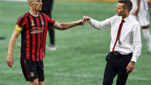 Atlanta United interim coach Stephen Glass gives midfielder Jeff Larentowicz a fist bump in celebration of a 1-0 victory against FC Dallas on Wednesday, Sept. 23, 2020, at Mercedes-Benz Stadium in Atlanta. Larentowicz scored the only goal of the match on a penalty kick. (Curtis Compton/Atlanta Journal-Constitution/TNS)
