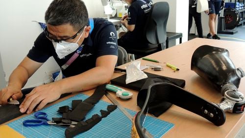 An Ottobock employee works in the Ottobock repair center at the Paralympic Village in Saint-Denis, near Paris, France, Saturday, Aug. 24, 2024. (AP Photo/Tom Nouvian)