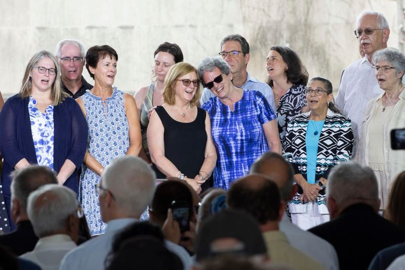 Peg Durachko, center left, and Carol Black, center right, hug as they participate in the breaking of the glass, at the end of the groundbreaking ceremony for the new Tree of Life complex in Pittsburgh, Sunday, June 23, 2024. The new structure is replacing the Tree of Life synagogue where 11 worshipers were murdered in 2018 in the deadliest act of antisemitism in U.S. history. Durachko's husband Richard Gottfried was killed in the attack and Black is a survivor. Also on stage are other survivors and family members of those killed in 2018. (AP Photo/Rebecca Droke)